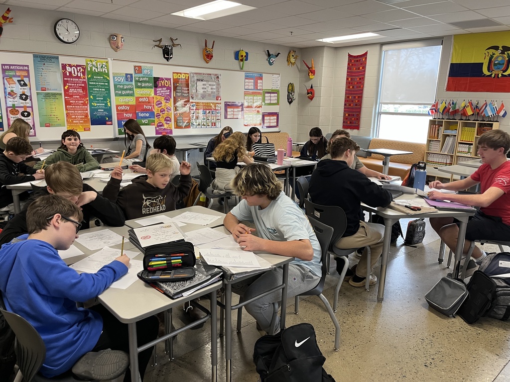 Students in Spanish class write poems about themselves in Spanish.