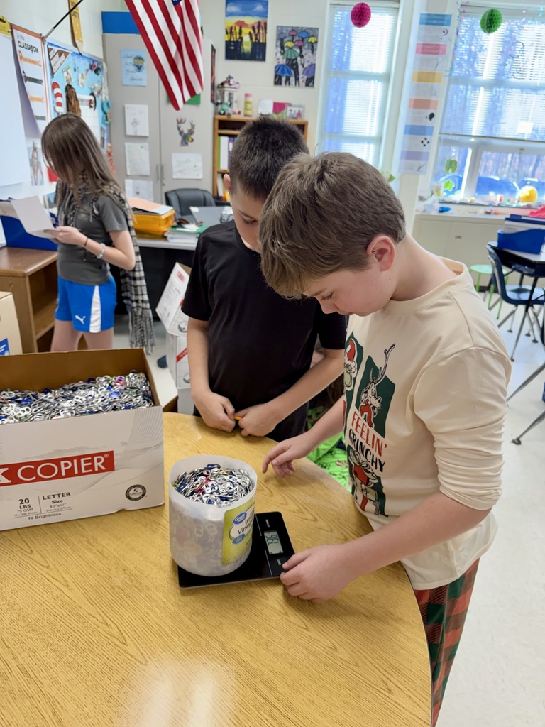 Students in a classroom weigh pop tabs.
