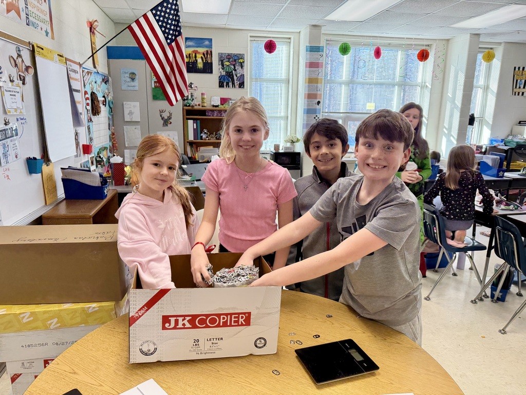 Students in a classroom weigh pop tabs.