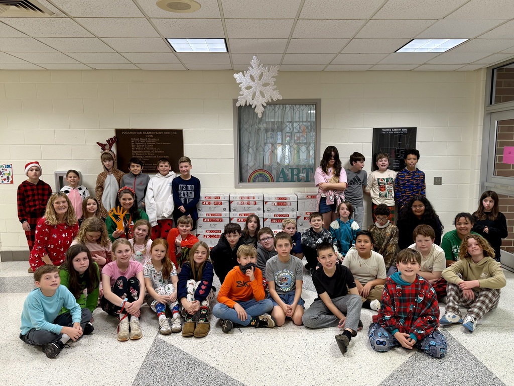 A large group of students and their teacher pose for a photo.