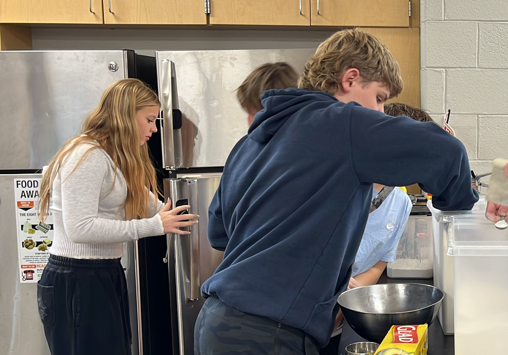 Students in a family and consumer sciences class work together to make pie dough from scratch.