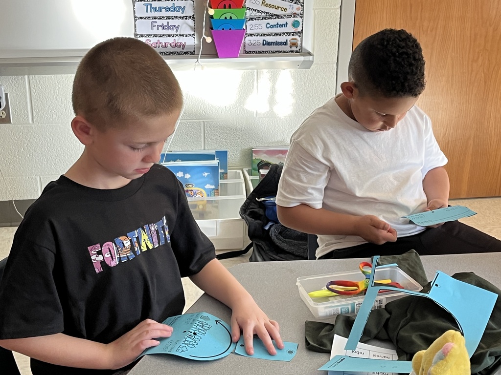 First graders work on a sun tracker in class. 