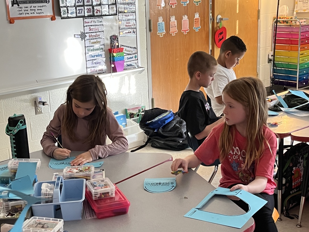 First graders work on a sun tracker in class. 