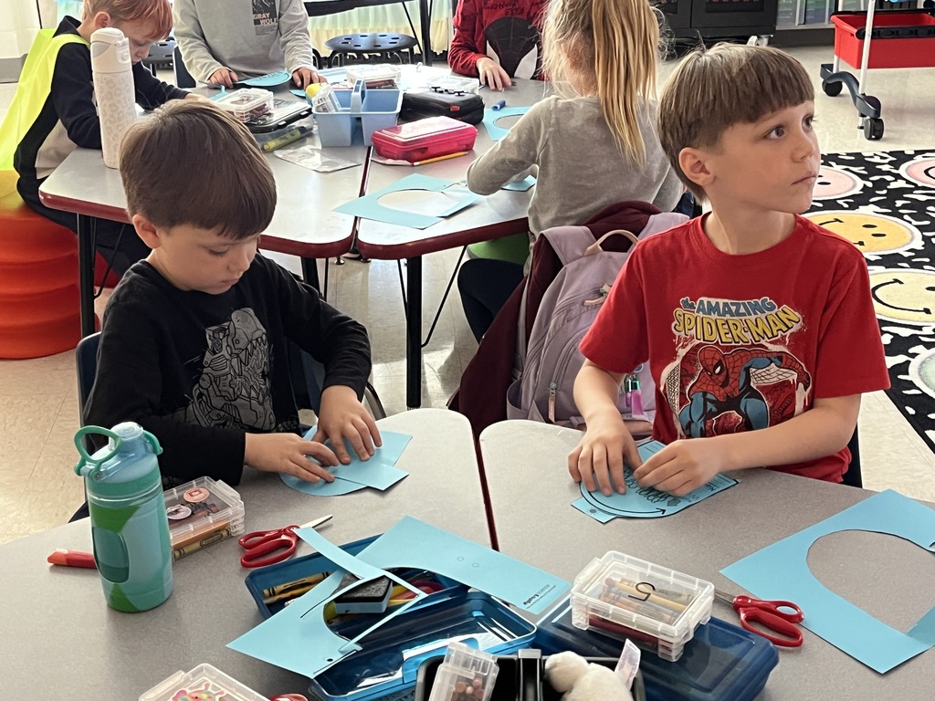 First graders work on a sun tracker in class. 