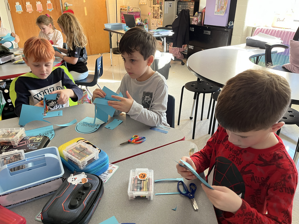 First graders work on a sun tracker in class. 