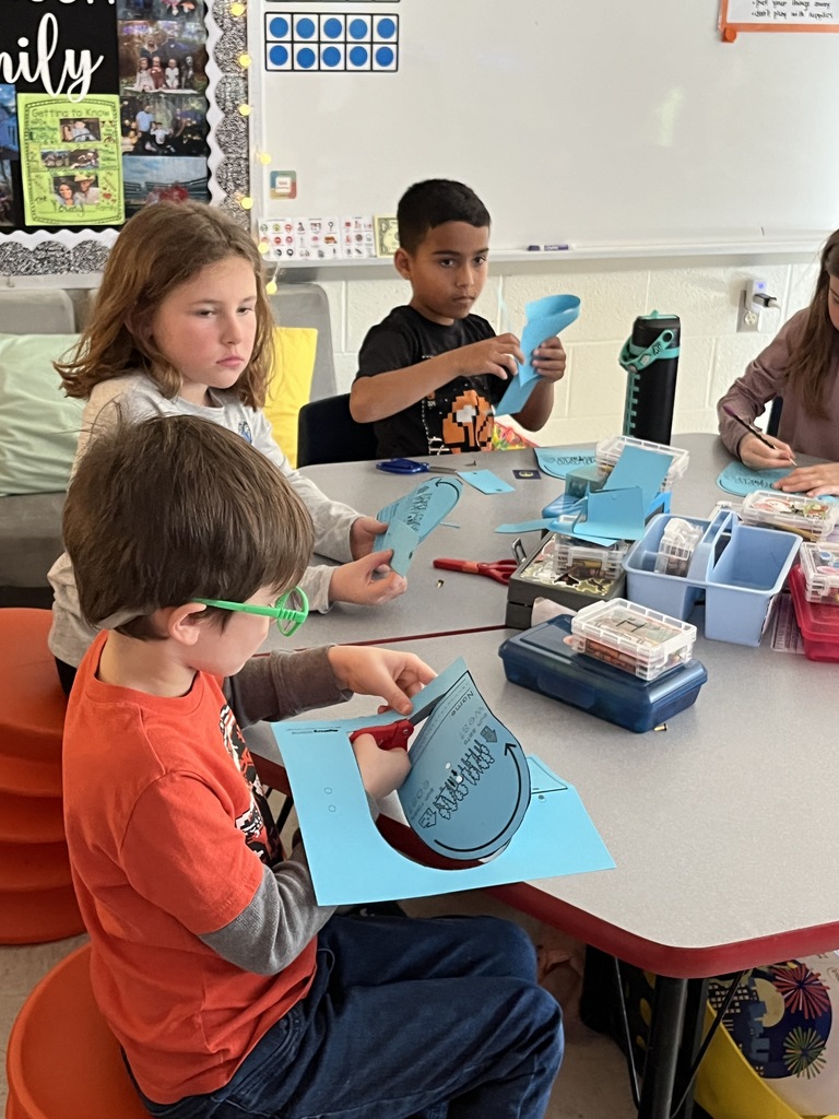 First graders work on a sun tracker in class. 
