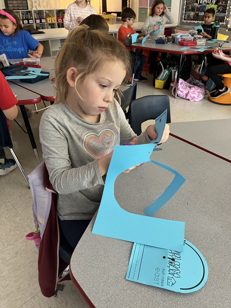 First graders work on a sun tracker in class. 