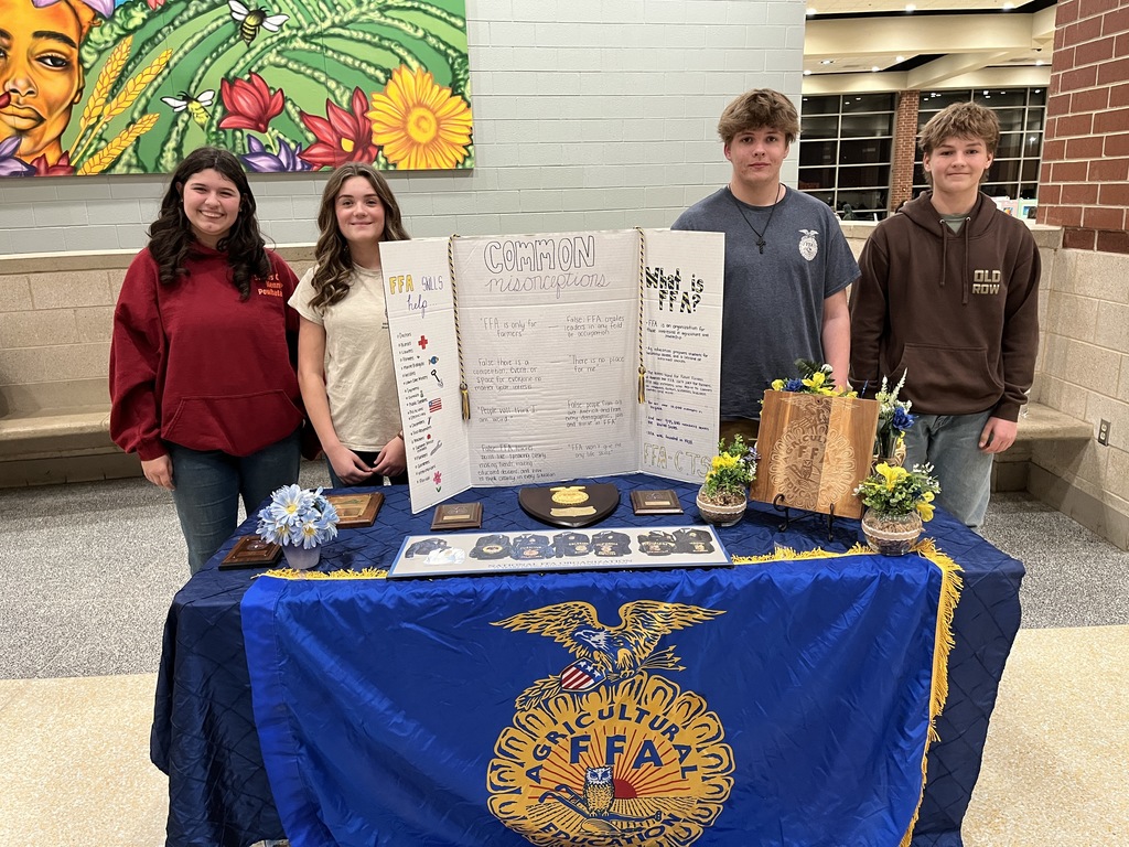 Students pose at a booth at a high school information night.