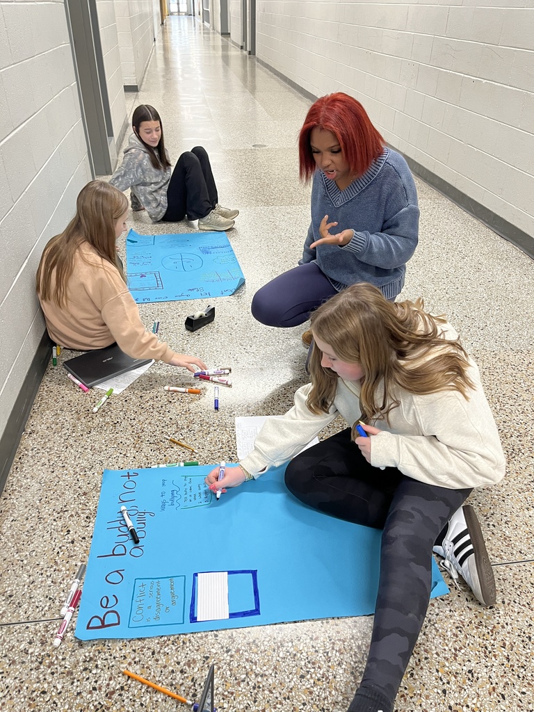 Students work on anti-bullying posters.