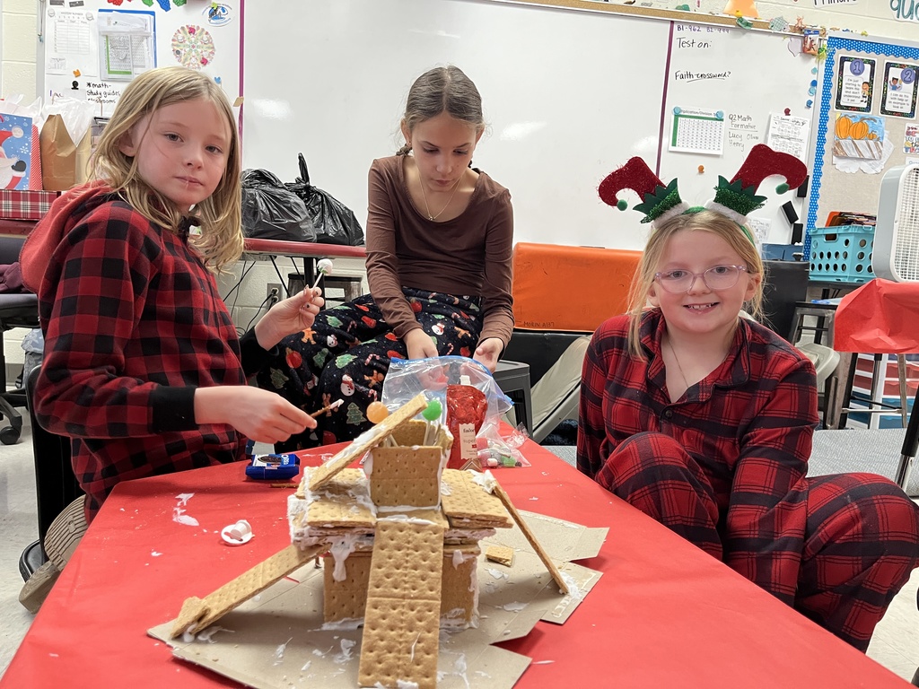 Students in class build gingerbread houses during a holiday party.