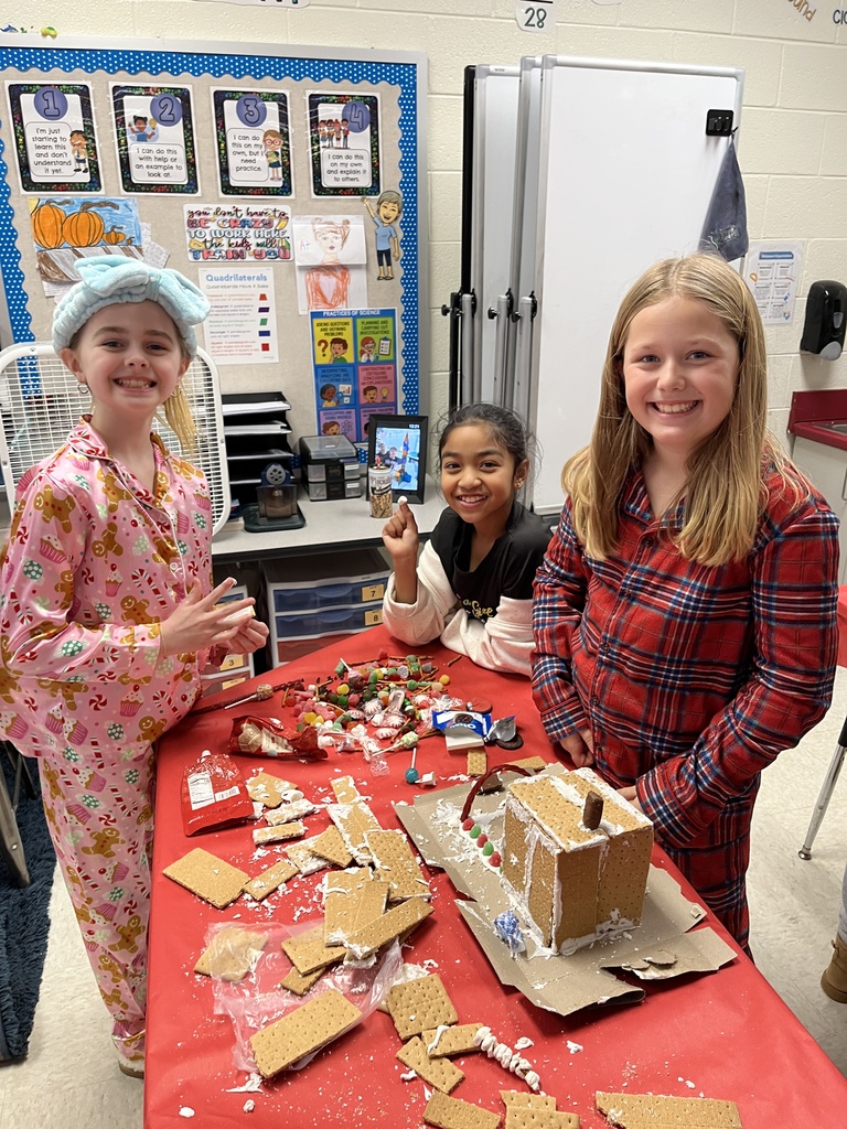 Students in class build gingerbread houses during a holiday party.