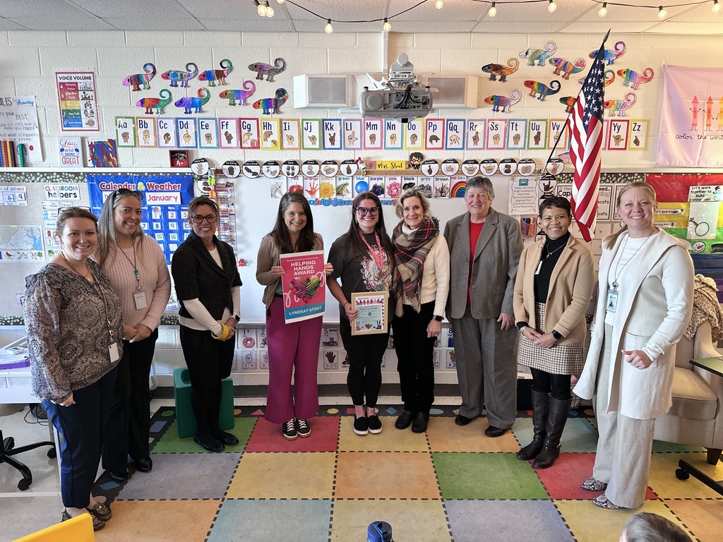 A group of adults pose for a photo. Some hold certificates.