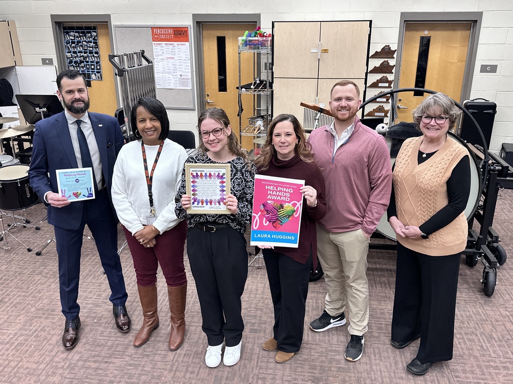 A group of adults pose for a photo. Some hold certificates.