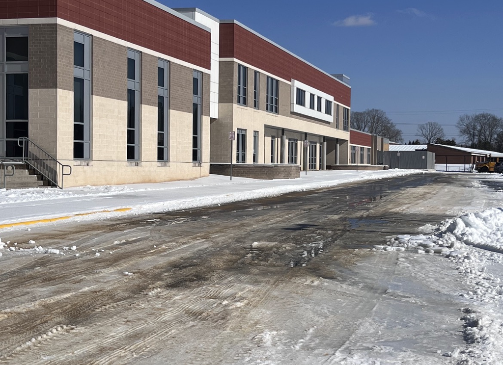 Photo of a school parking lot covered in ice and snow.