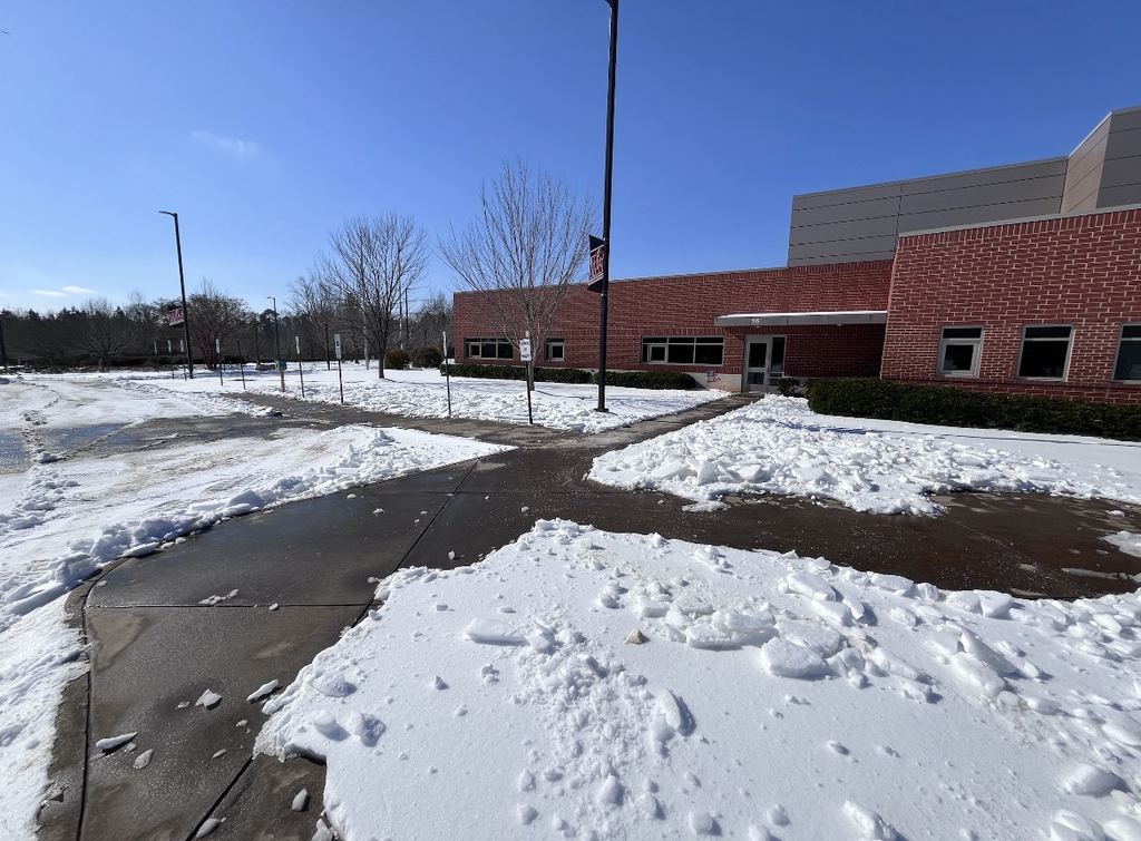 Photo of a school parking lot covered in ice and snow.