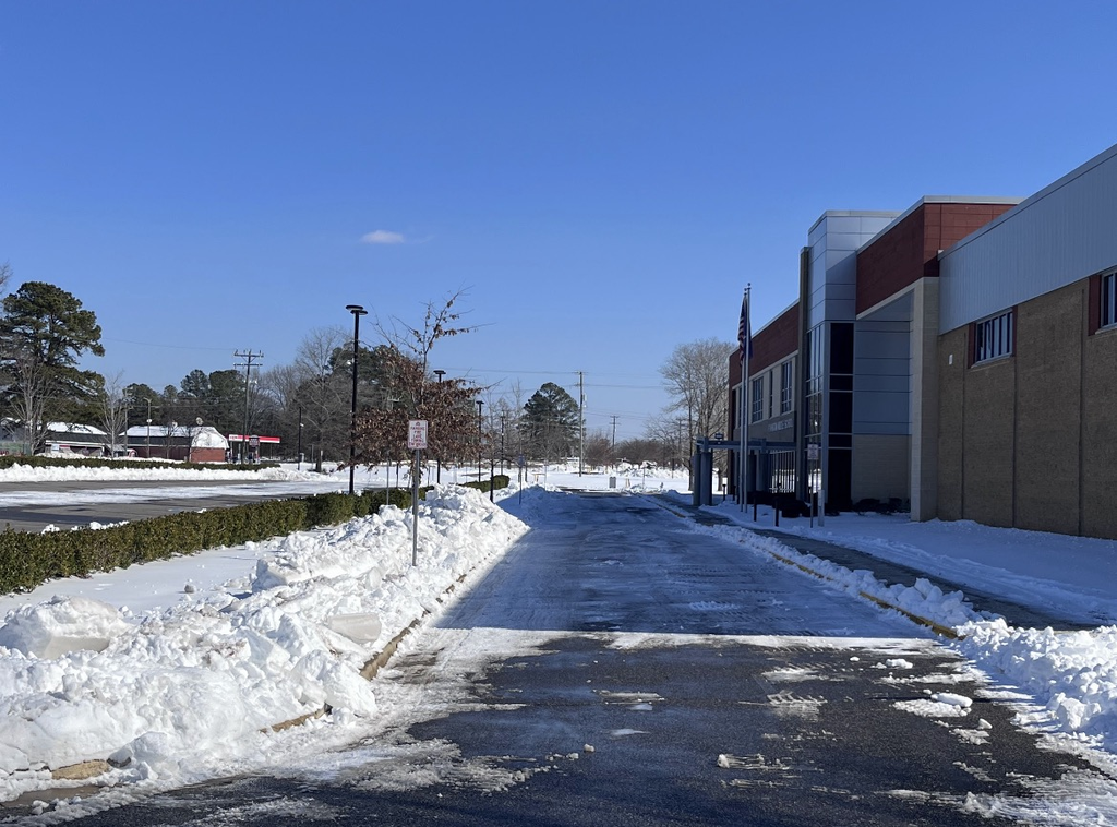 Photo of a school parking lot covered in ice and snow.