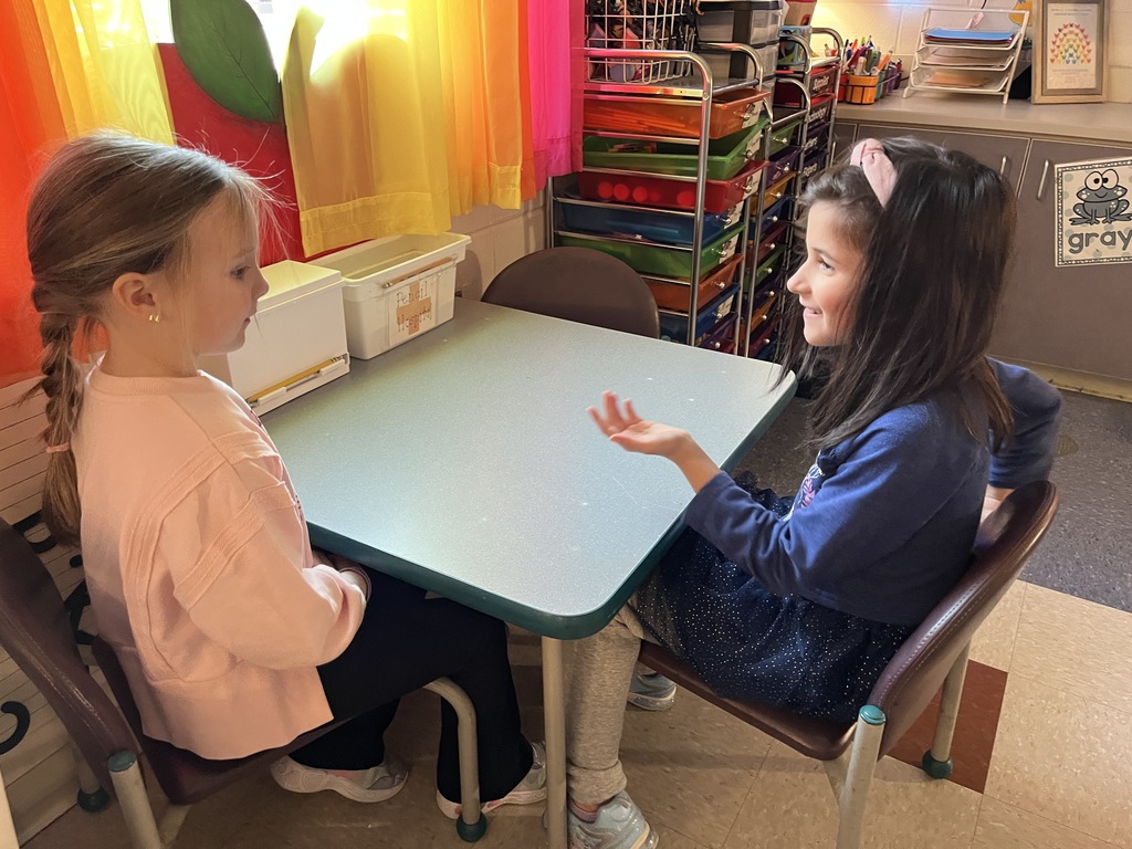 Students use math manipulatives  to learn about the parts of five.