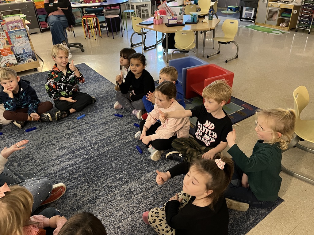 A teacher uses math manipulatives with her students to learn about the parts of five.