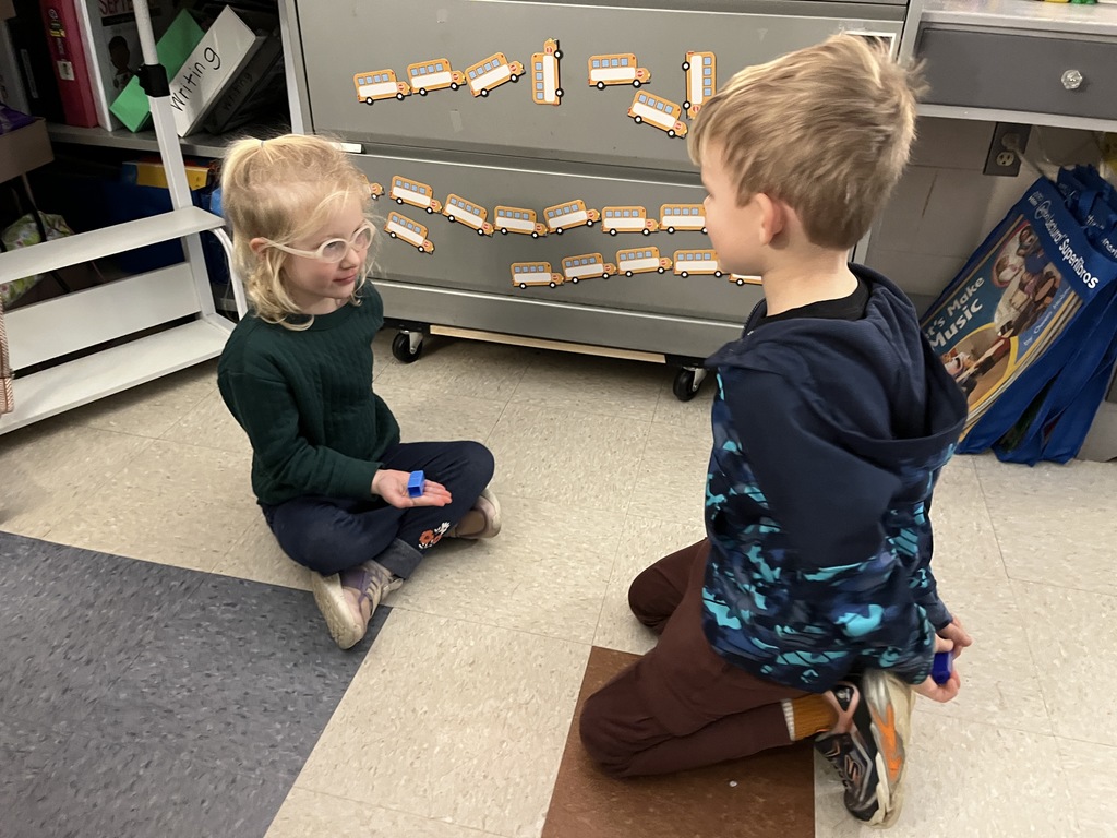 Students use math manipulatives  to learn about the parts of five.