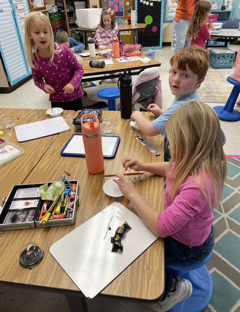 Kindergarteners in class makes personal snowmen using crushed ice.