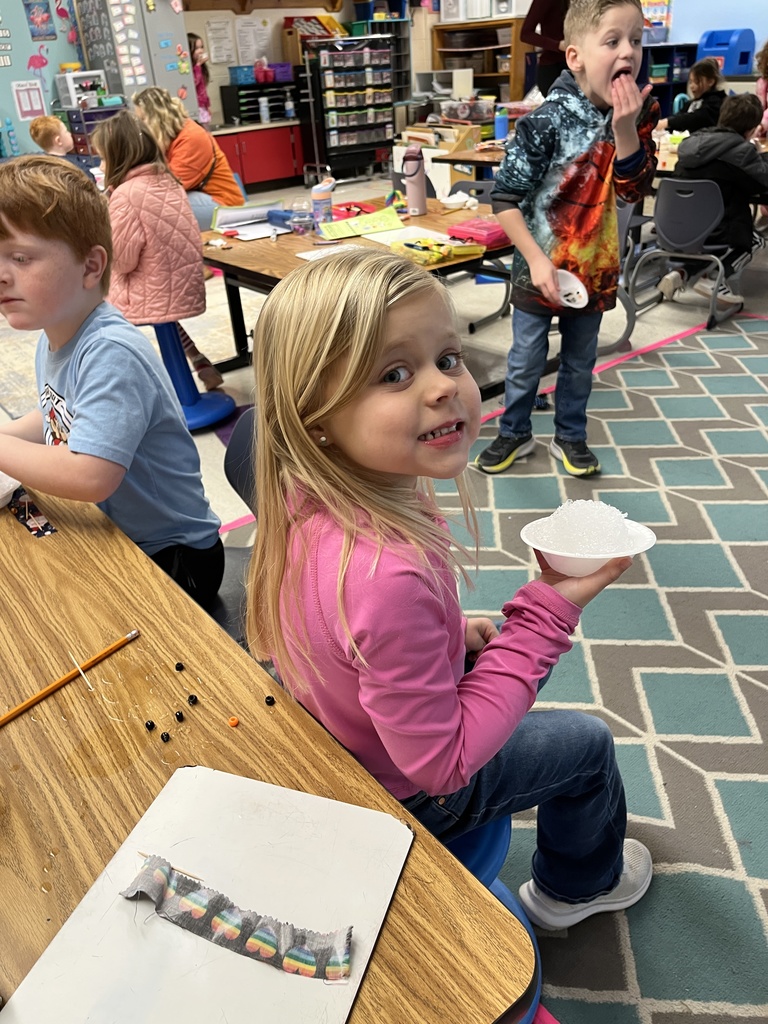 Kindergarteners in class makes personal snowmen using crushed ice. 