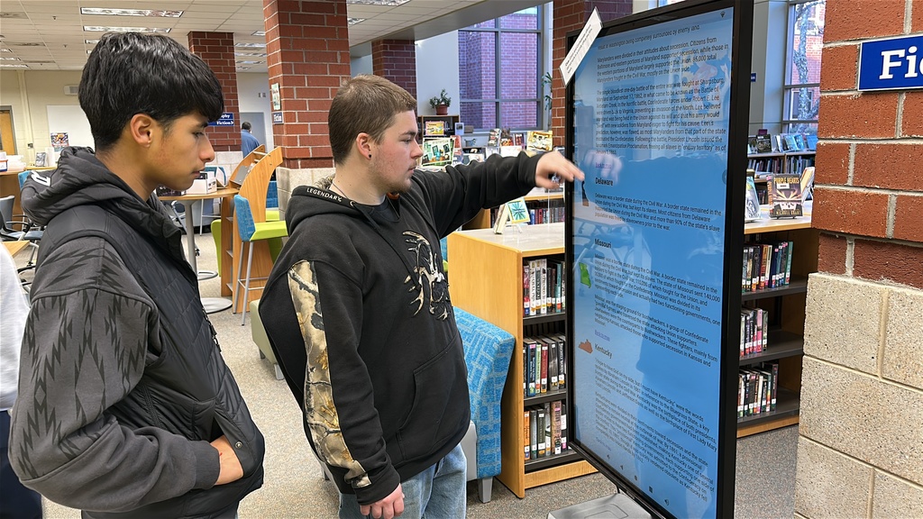 Students participate in a Civil War scavenger hunt in the school library.