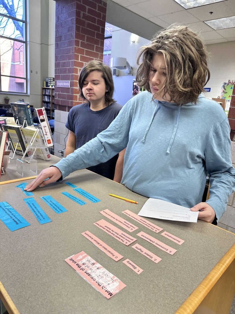 Students participate in a Civil War scavenger hunt in the school library.
