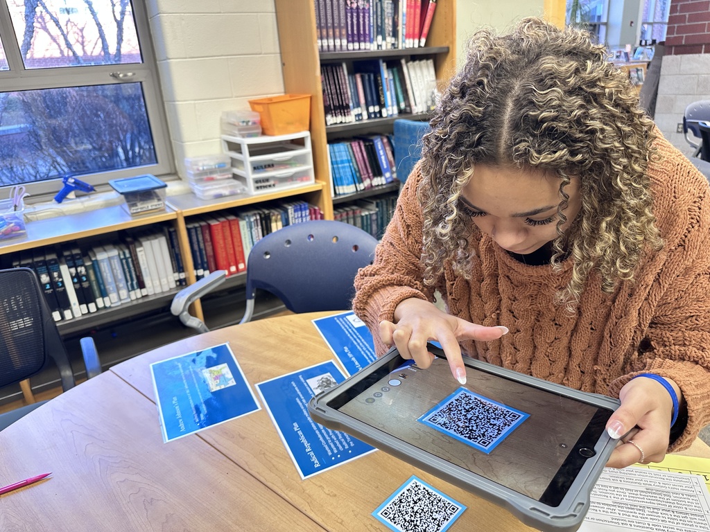 A student participates in a Civil War scavenger hunt in the school library.