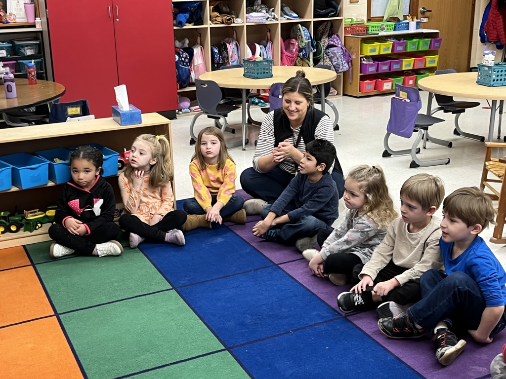 Students in a preschool class do an activity around the letter N with their teacher.