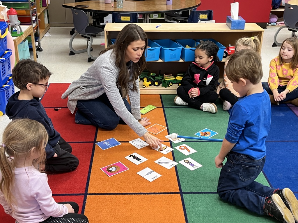 Students in a preschool class do an activity around the letter N with their teacher.