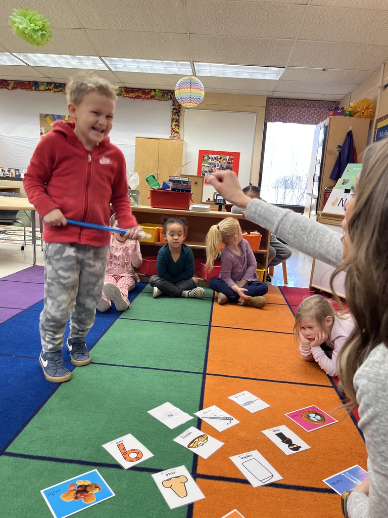Students in a preschool class do an activity around the letter N with their teacher.