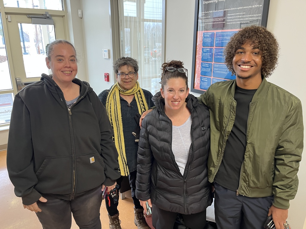 Four adults pose for a photo.