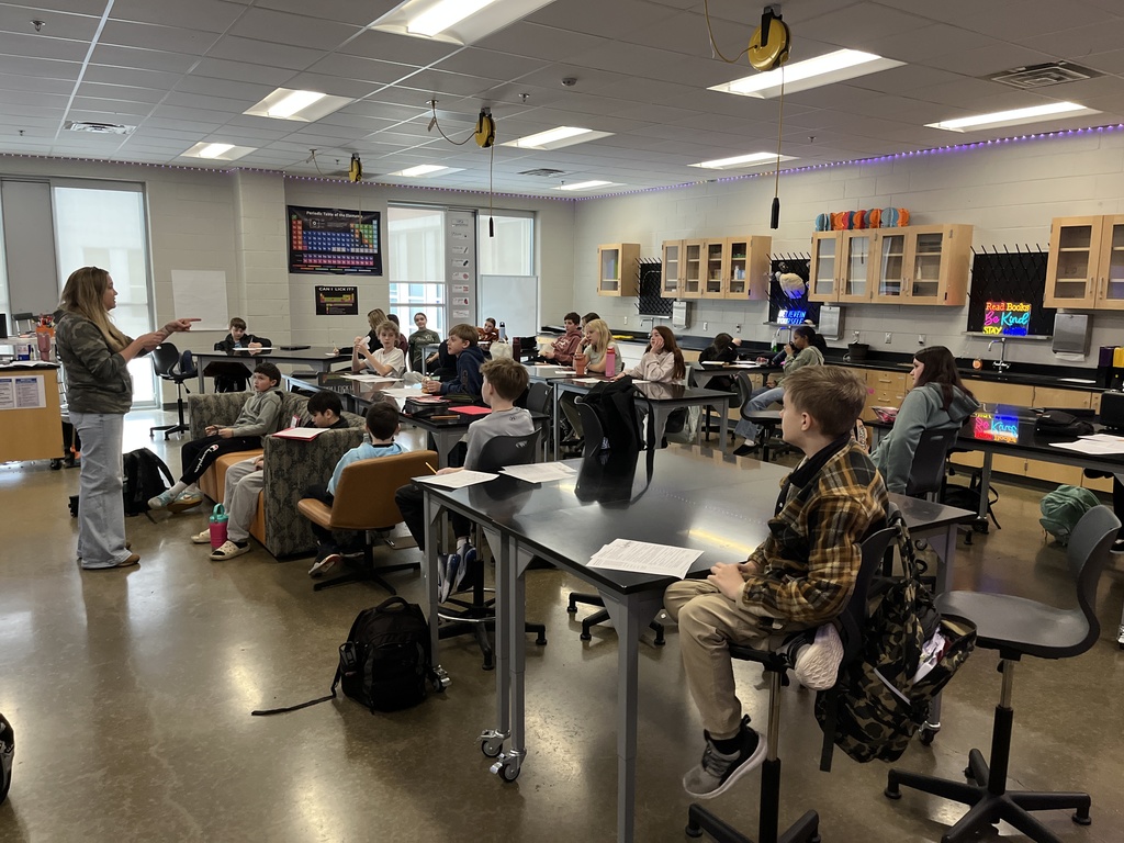 A teacher speaks to a classroom of students. 