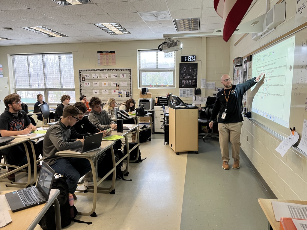 A teacher speaks to a classroom of students. 