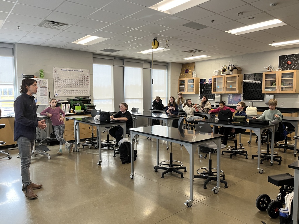 A teacher speaks to a classroom of students. 