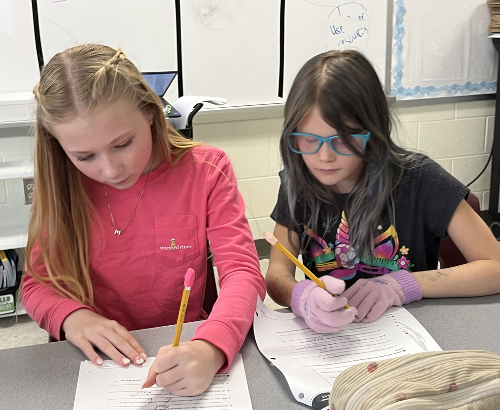 Students work on a lesson focused on strengthening grammar skills by working on consistent verb tenses. 