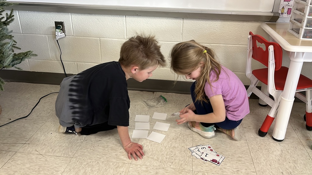 Students use cards to practice addition skills by making combinations to get to the number 3. 