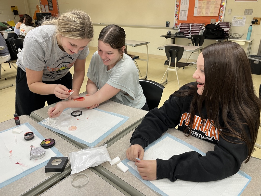 Students use makeup techniques to create realistic wounds and bruises as part of their study of the skin.