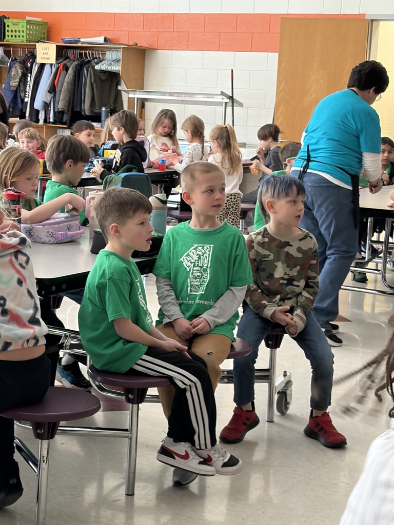Elementary students watch the Olympics at lunch.