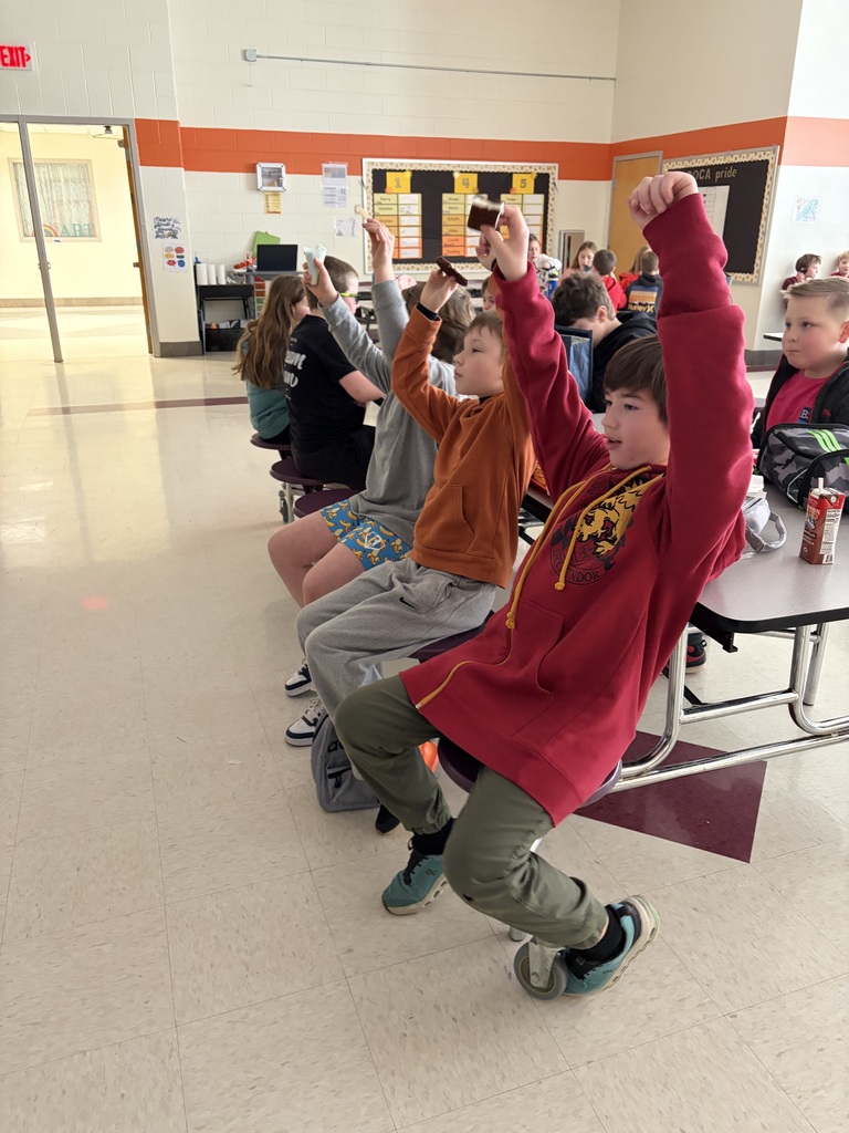 Elementary students watch the Olympics at lunch and cheer.