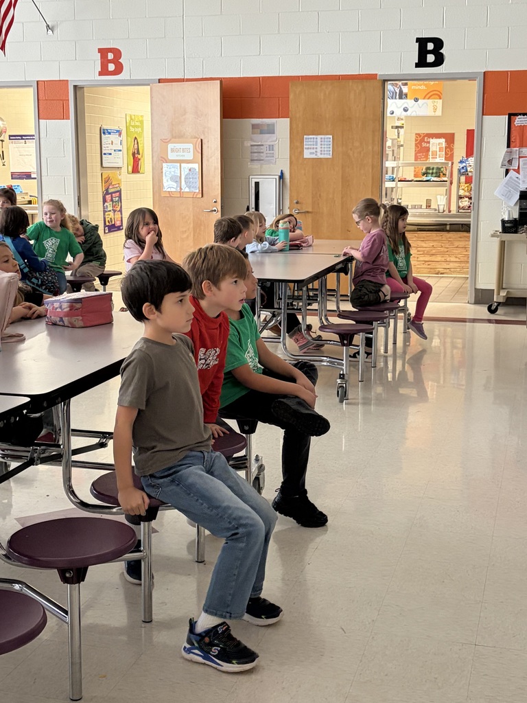 Elementary students watch the Olympics at lunch.