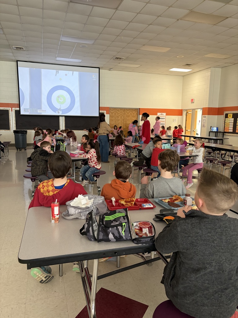 Elementary students watch the Olympics at lunch.