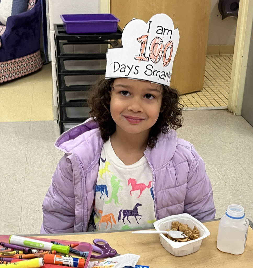 A child dressed up for the 100th day of school poses for a photo.