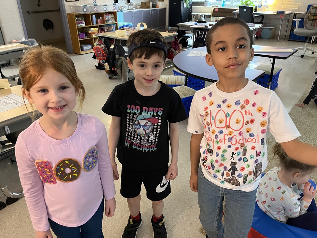 Children dressed up for the 100th day of school pose for a photo.