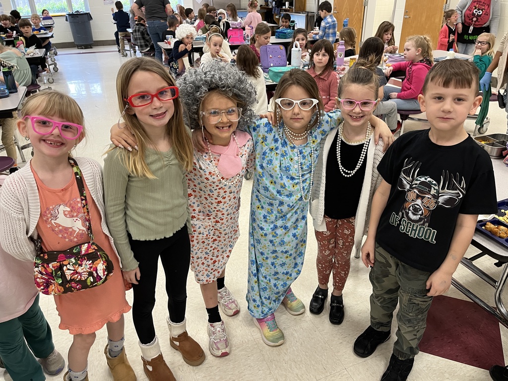 Children dressed up for the 100th day of school pose for a photo.