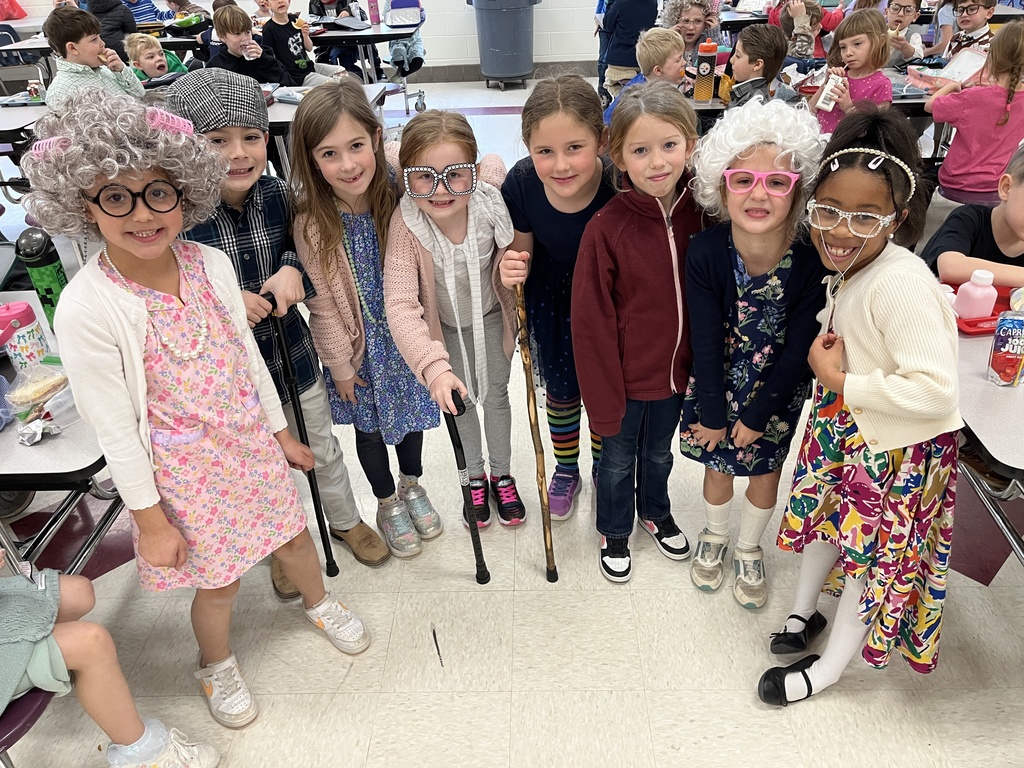 Children dressed up for the 100th day of school pose for a photo.