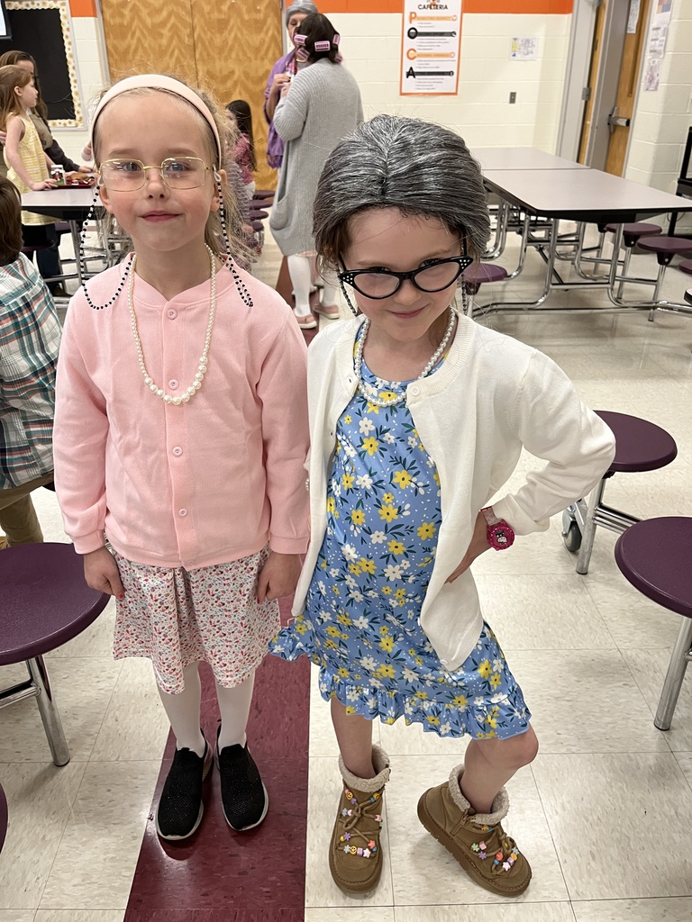 Children dressed up for the 100th day of school pose for a photo.