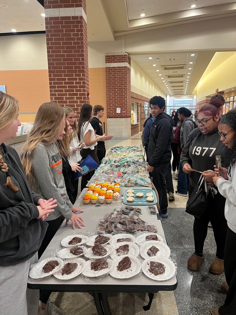 Students hold a bake sale and sell to other students. 