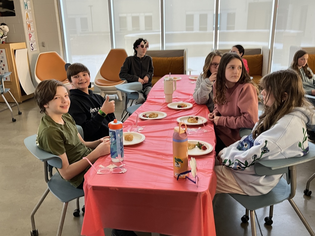 Students in French calss meet in the library to help choose a semester book.