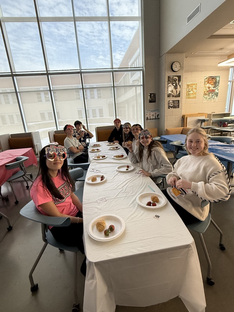 Students in French calss meet in the library to help choose a semester book.